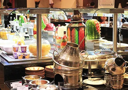 Buffet display with food, drinks, and colorful lanterns