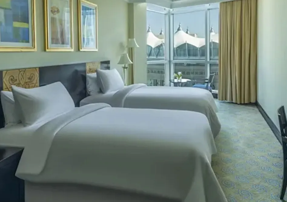 /media/umrah-images/2-single-beds-room%20%283%29.webp