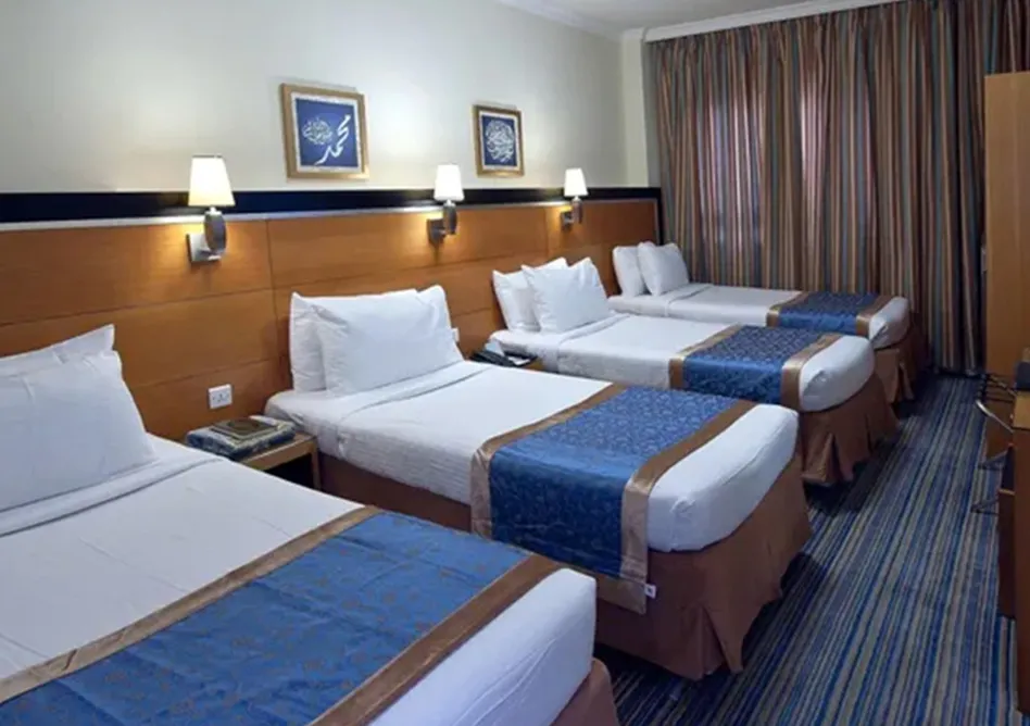 /media/umrah-images/4-single-beds-room%20%283%29.webp