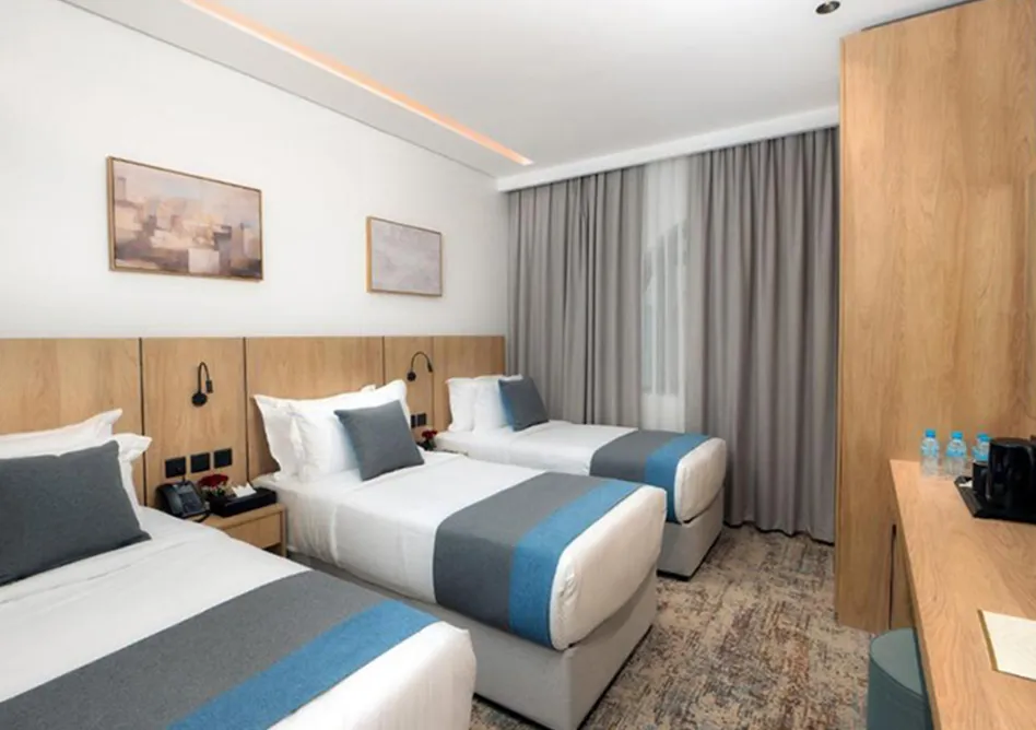 /media/umrah-images/room-with-3-single-beds%20%282%29.webp