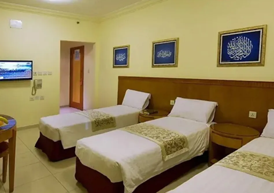 /media/umrah-images/room-with-3-single-beds.webp